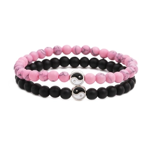 Matching Yin Yang couple beaded bracelets in matte black and pink marble stone texture