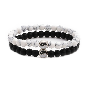 Close-up of matte black and white marble stone bracelets with Tai Chi Yin Yang symbols