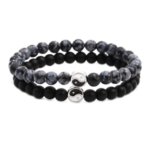 Detail of double-layer beaded bracelet set featuring obsidian and matte onyx with yin yang charms