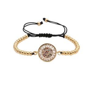 Adjustable gold beaded bracelet featuring a sun-burst pendant with colorful zircon stones