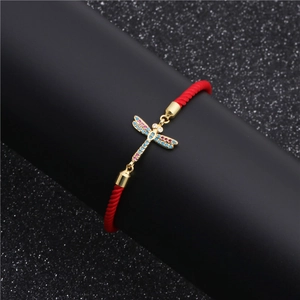 Adjustable red rope bracelet with a gold-plated dragonfly charm set with colorful zircons