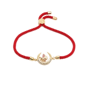 Adjustable red cord bracelet with a gold crescent moon and butterfly zircon pendant