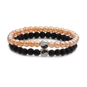 Close-up of Tai Chi Yin Yang beaded bracelets with champagne and matte black stones