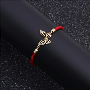 Elegant red woven rope bracelet with gold hollow butterfly pendant set with colorful gems