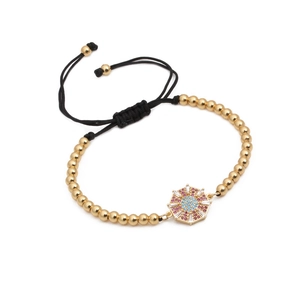 Bracciale intrecciato regolabile con perle dorate e ciondolo sole con zirconi colorati