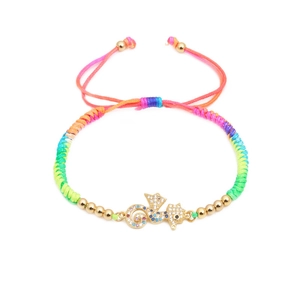 Adjustable rainbow woven bracelet featuring a gold seahorse charm with colorful zircons