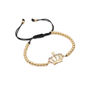 Handmade woven bead bracelet with gold metal beads and a colorful zircon crown charm