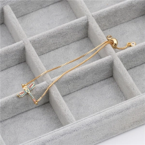 Elegant gold dragonfly bracelet with blue and pink cubic zirconia and adjustable slide chain