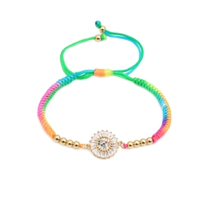 Detailed shot of rainbow braided bracelet with colorful zircon sunflower pendant and gold beads