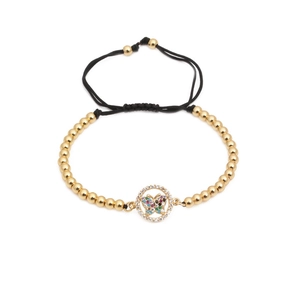 Detail of colorful zircon butterfly charm and 4mm polished gold beads on woven bracelet