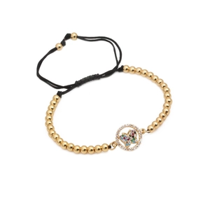 Detail of 4mm gold beads bracelet with a micro-paved zircon butterfly in round pendant