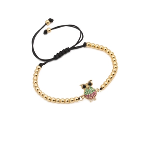 Adjustable woven bracelet featuring golden beads and micro-pave zircon owl charm