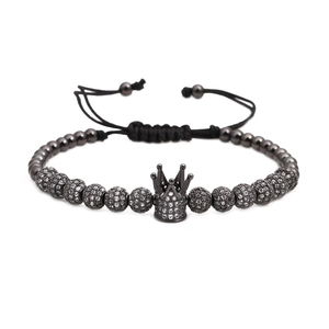 Men's woven bracelet with black crown charm and micro-paved zircon beads on white background