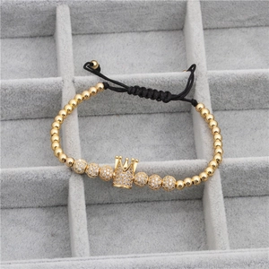 Macro view of adjustable woven bracelet featuring a gold crown and micro-pave zircon beads