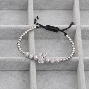 Detailed macro shot of a micro-paved zircon crown bead on a braided adjustable bracelet