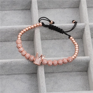 Close-up of rose gold crown woven bracelet with micro-pave zircon beads and black cord