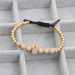Detail of gold crown bracelet with micro-pave zircon beads on black woven cord