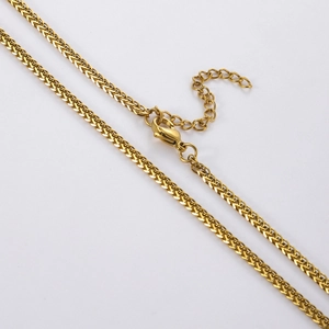 Macro detail of gold Spiga chain necklace with lobster clasp and adjustable link chain