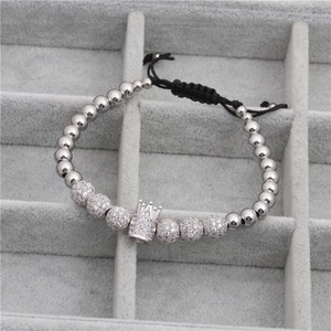 Macro shot of crown bracelet with pavé cubic zirconia balls and woven adjustable cord