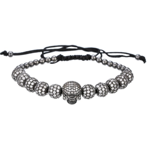 Adjustable woven bracelet featuring micro-paved zircon skull and metallic beads on white