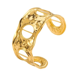 Hammered gold wide open cuff bracelet with circular cutouts for a bold luxury look