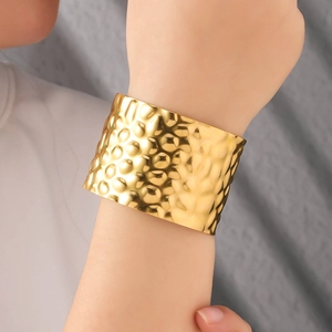 Minimalist wide open cuff bracelet with 18K gold plating and hammered metal texture