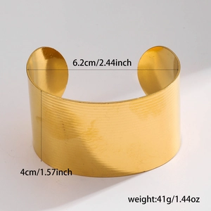 Wide gold-tone irregular textured cuff bracelet with elegant open-end minimalist design