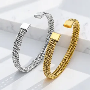 Detailed macro view of woven mesh open bracelets in gold and silver stainless steel finish