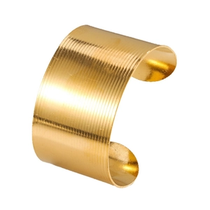 Elegant gold-tone wide cuff bracelet featuring a stylish ribbed horizontal texture design
