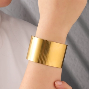 Elegant wide gold irregular cuff bracelet with brushed texture for women on wrist