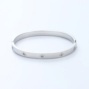 Polished stainless steel bangle with etched star patterns and zircons in silver finish
