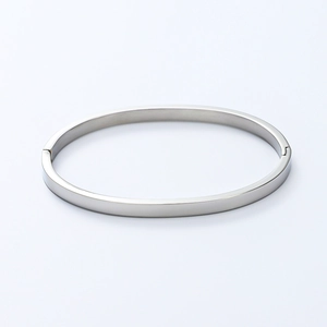 Detail of silver polished stainless steel bangle showing the hinge closure and sleek finish