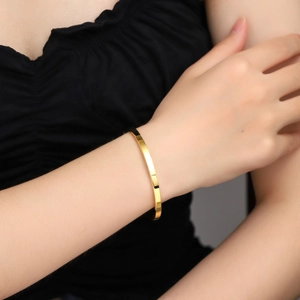 Minimalist 4mm 18K gold plated titanium steel striped bangle shown on wrist
