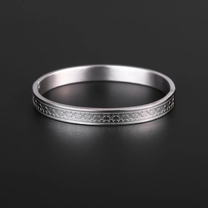 Detailed macro view of 18K gold plated titanium steel bracelet with star pattern engraving