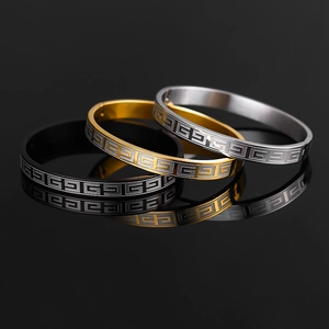 Polished titanium steel bracelets in black, gold, and silver with Greek key pattern