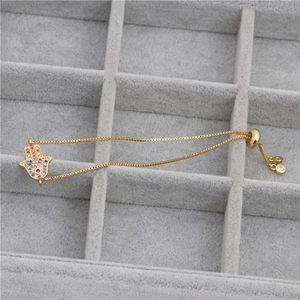 Luxurious gold Hamsa Hand bracelet featuring vibrant multi-color cubic zirconia stones