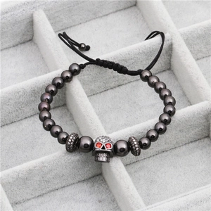 Micro-pave zircon skull beaded bracelet with hematite-style beads and red eyes