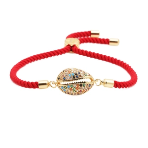 Red braided rope bracelet with golden shell charm and colorful micro-set zircons