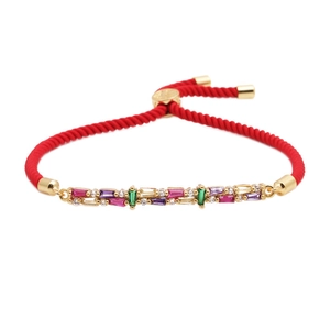 Handmade red braided cord bracelet featuring multi-colored cubic zirconia and gold accents