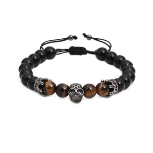 Detail of beaded bracelet showing natural black agate, tiger eye stones, and skull charm