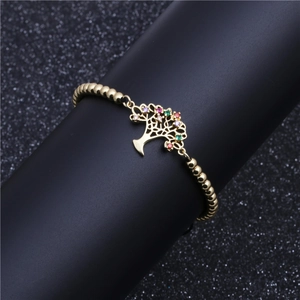 Golden beaded bracelet featuring a micro-pave multicolor zircon Tree of Life charm
