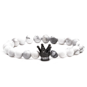Elegante pulsera de cuentas de mármol blanco con dije de corona negra y microcirconitas