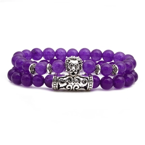 Vue détaillée des perles d'améthyste violettes avec breloque tête de lion en argent
