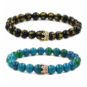 Detail of beaded crown bracelets featuring black mantra beads and turquoise style beads
