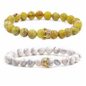 Close-up of 8mm natural stone beads with golden crown charms for DIY bracelets