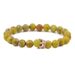 Close-up of 8mm emperor stone beads and rose gold crown charm on a stretch bracelet