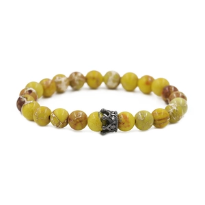 Detail of 8mm green emperor stone beads and a black metal crown charm on a bracelet