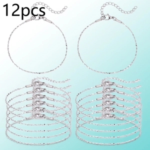 Detail view of 12 silver-tone twisted chain bracelets with lobster clasps and extenders