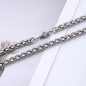 Macro shot of stainless steel wheat chain link with lobster clasp for men's necklace