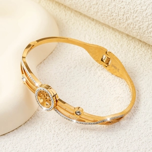 Detailed close-up of tree of life stainless steel bangle with sparkling white rhinestones